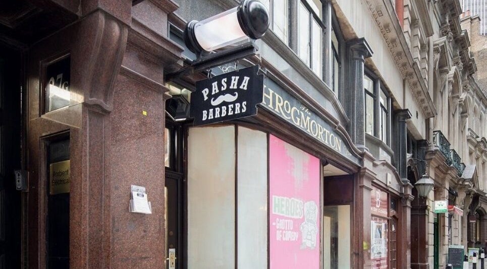 Exterior of Pasha Barbers, Bank located in London, England, GB with iconic signage on a busy street.