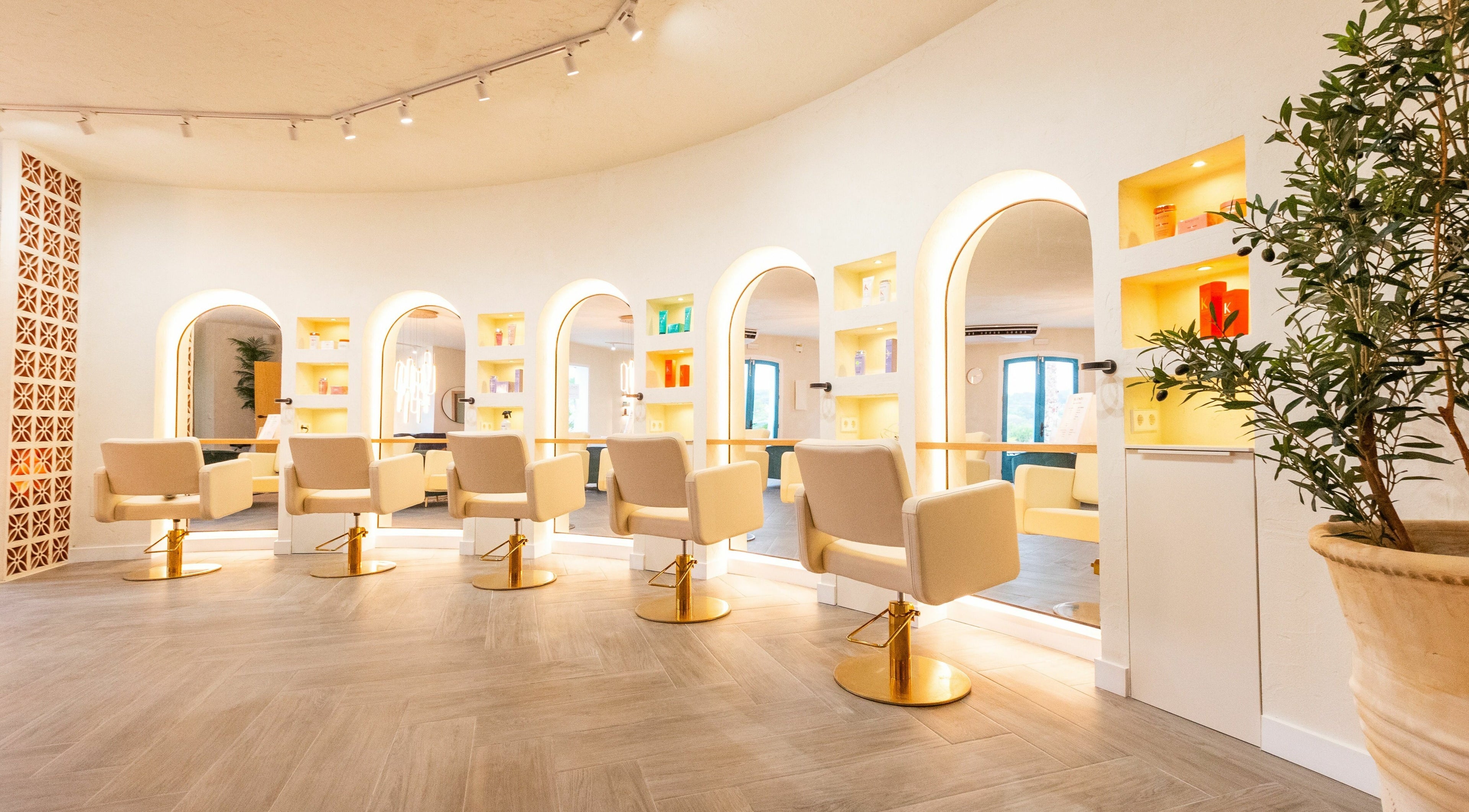 Luxurious seating and mirrors at BLONDI salon, Sotogrande, Andalucía, ES, illuminated for elegance.