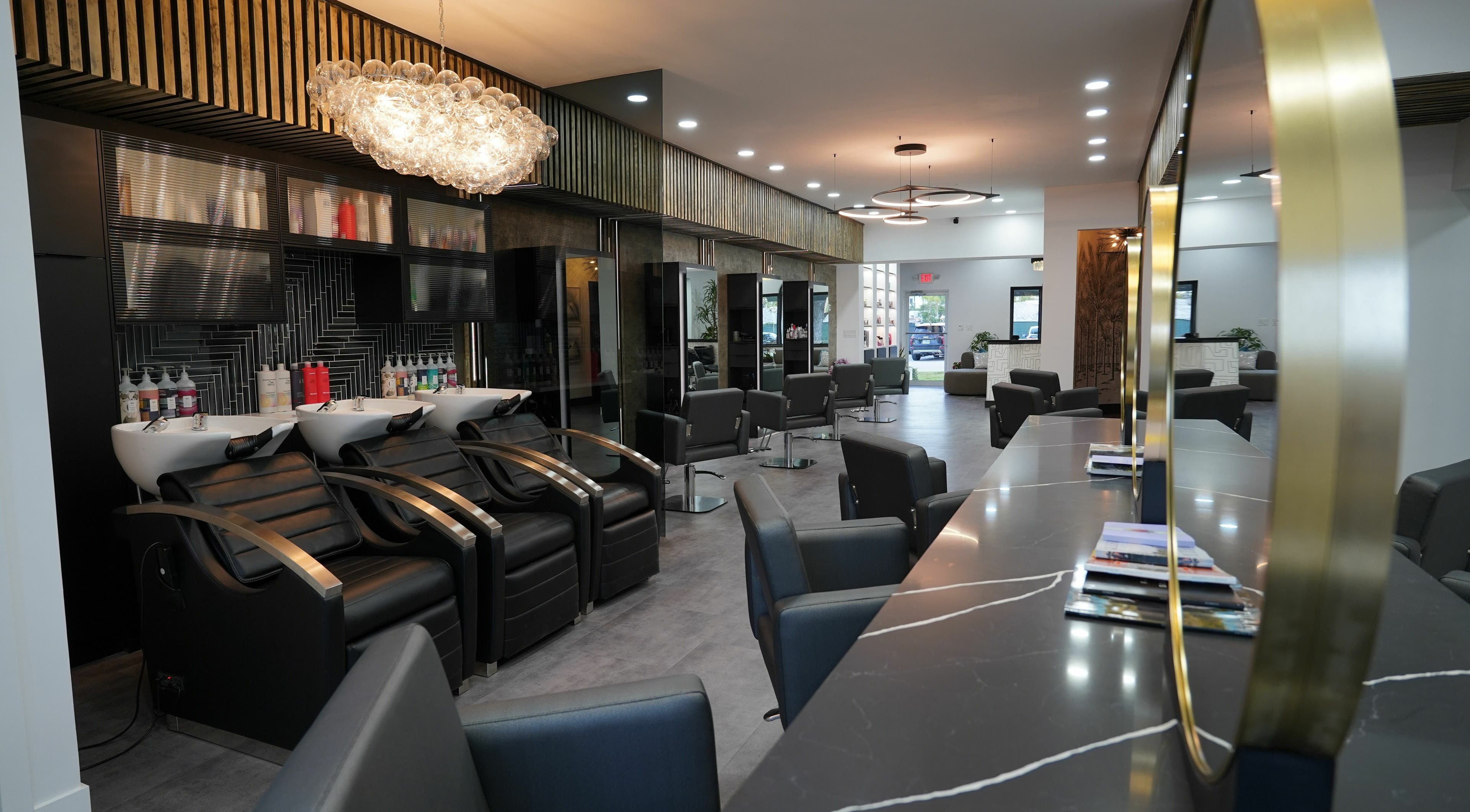 Modern interior of Salon Lusso of Naples, featuring stylish chairs and lighting in Naples, Florida, US.