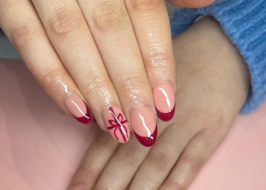Stylish nail art with red tips at Nail Artistry by Chelsea in Gqeberha, Eastern Cape, ZA.