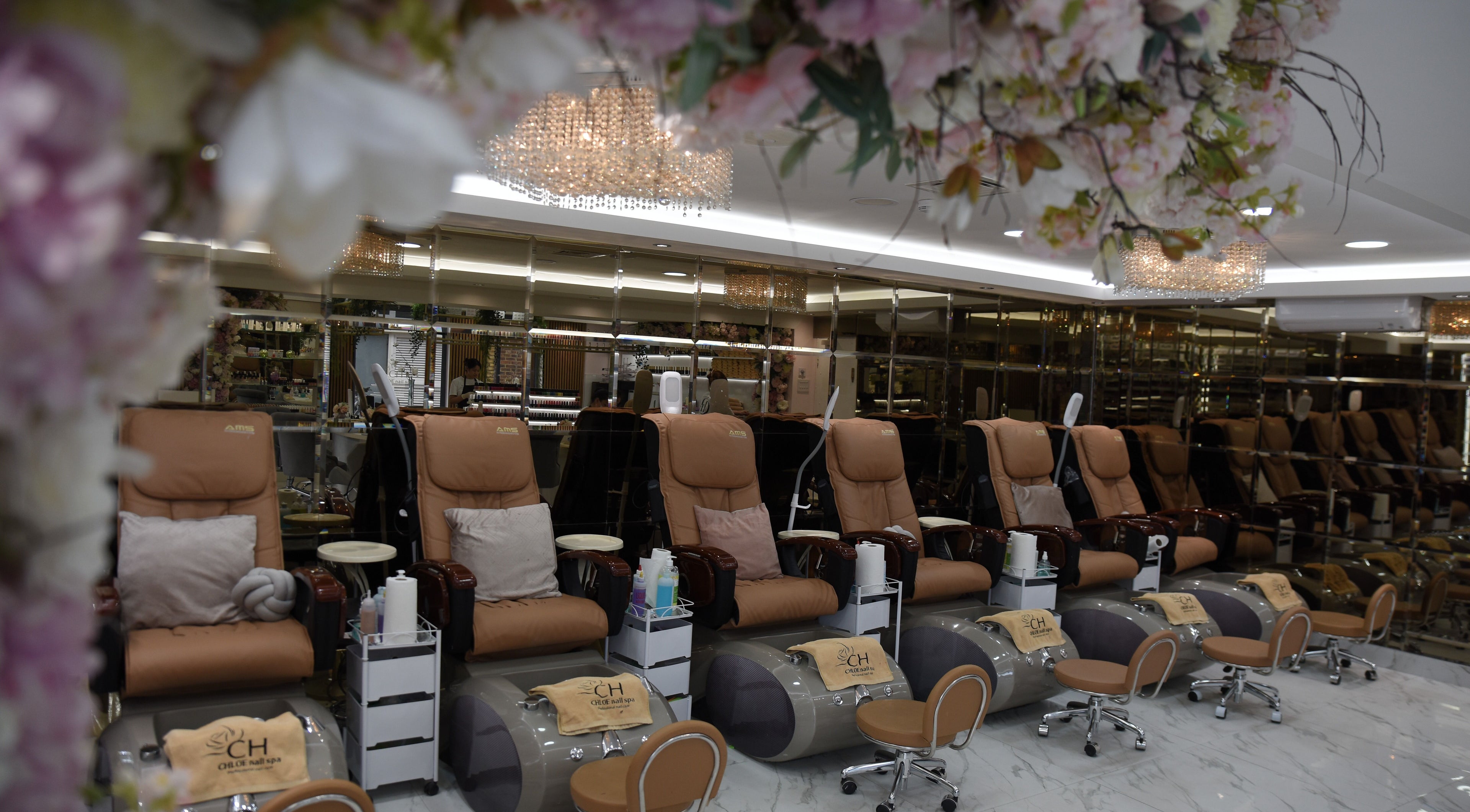 Chloe Nail Spa pedicure chairs with floral decor, London, England, GB.