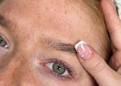 Eyebrow styling at STUDIO24, Swords, County Dublin, IE. Close-up of groomed brows and polished nails.