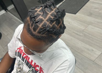 Intricate twisted hairstyle at Princess Parlour, Nottingham, England, GB.