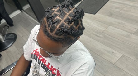 Intricate twisted hairstyle at Princess Parlour, Nottingham, England, GB.