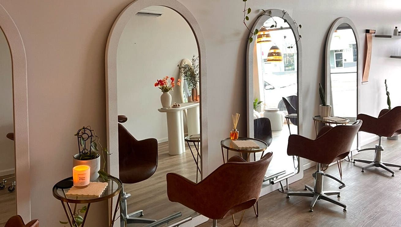 Chic salon setup at Two by the Sea Salon, Christies Beach, South Australia, AU with stylish mirrors and chairs.