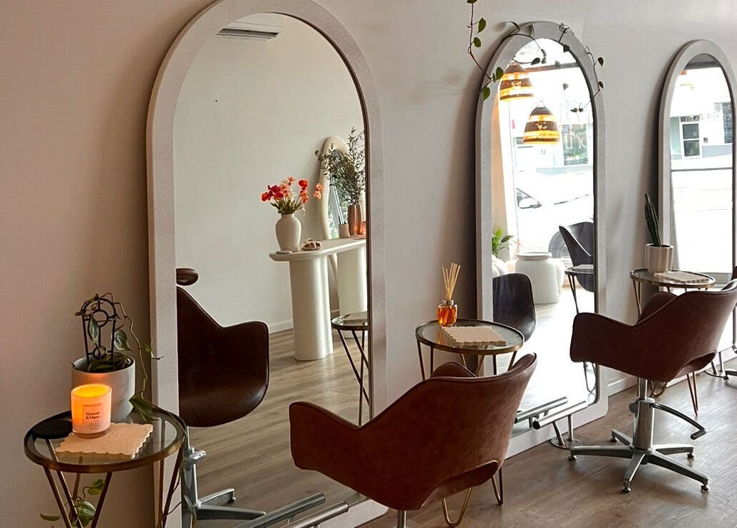 Chic salon setup at Two by the Sea Salon, Christies Beach, South Australia, AU with stylish mirrors and chairs.