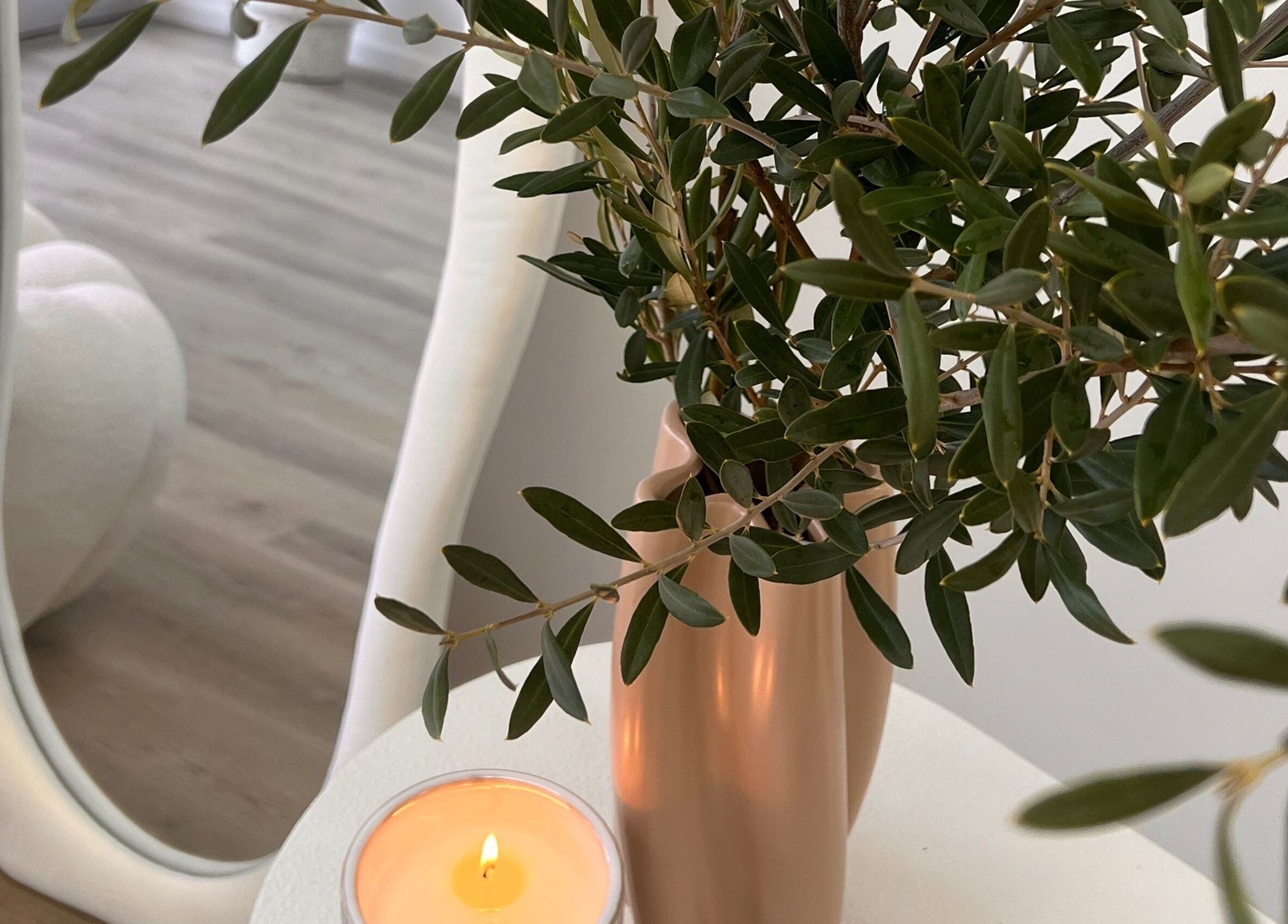 Calming decor at Two by the Sea Salon, Christies Beach, South Australia, AU with a candle and plant reflection.