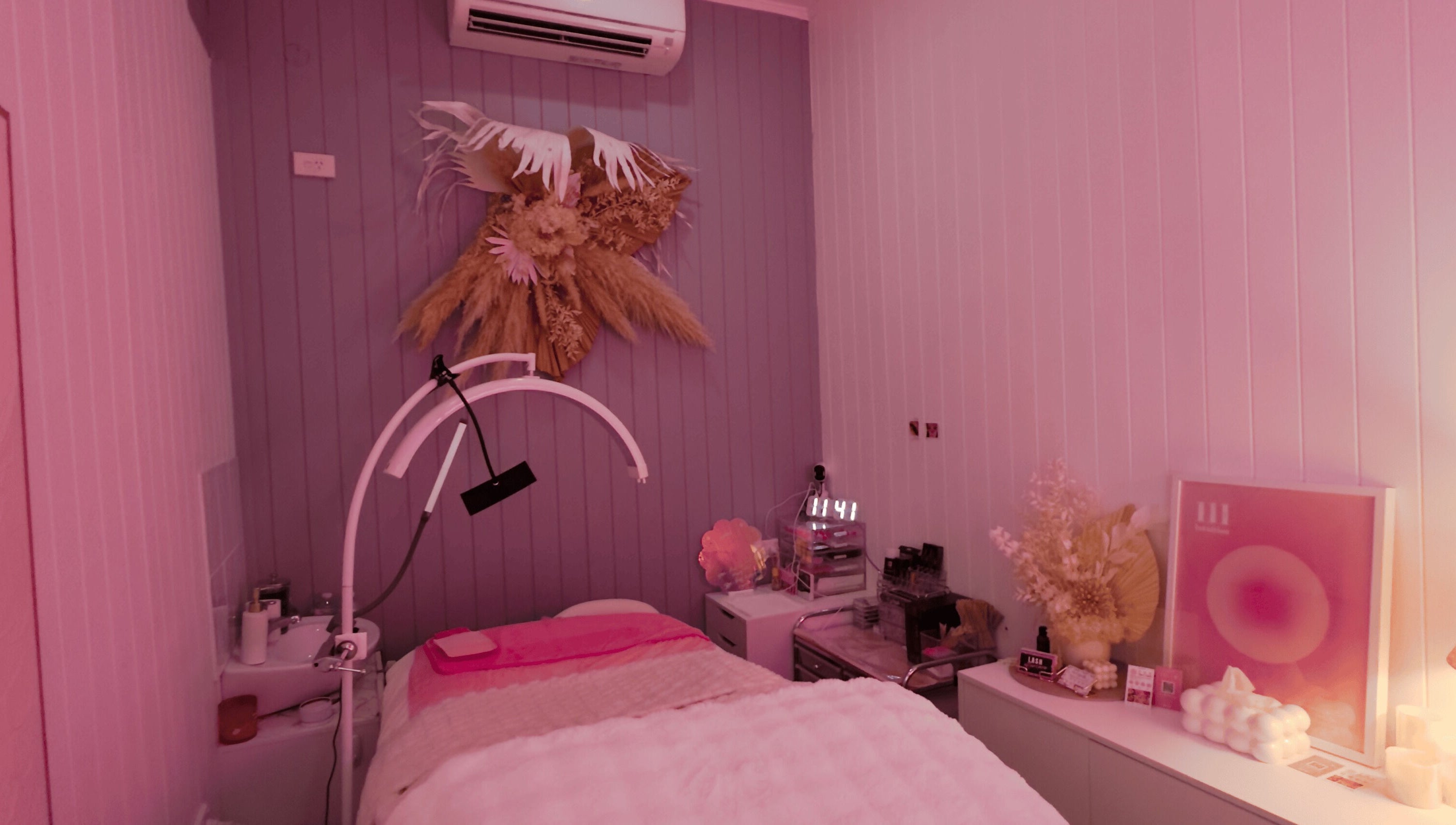 Relaxing wellness room at Lyricstudiox in Saint Lucia, Queensland, AU, featuring stylish decor and modern treatment setup.