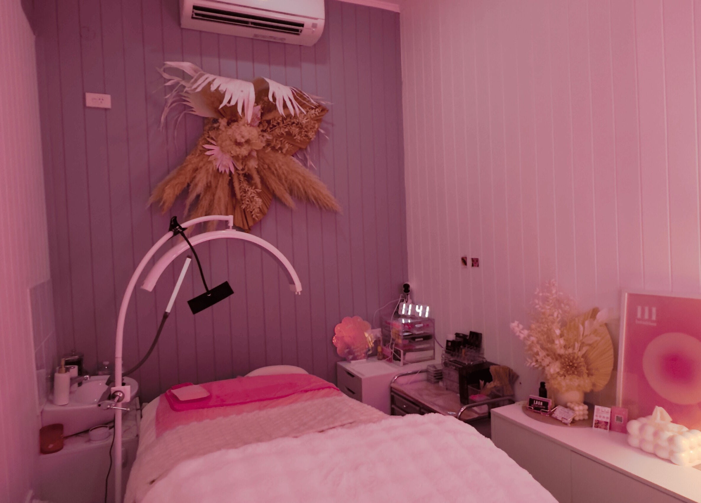 Relaxing wellness room at Lyricstudiox in Saint Lucia, Queensland, AU, featuring stylish decor and modern treatment setup.