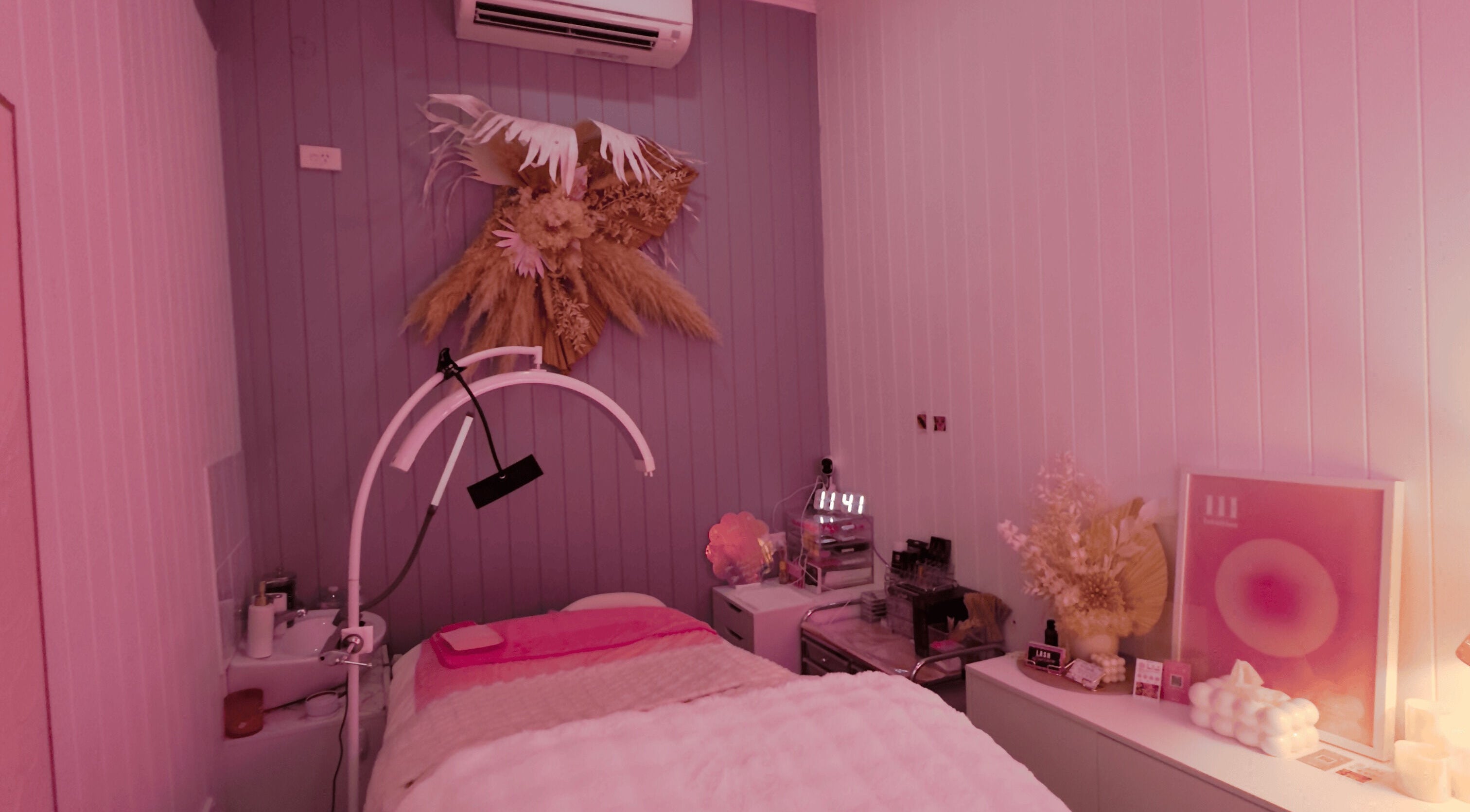 Relaxing wellness room at Lyricstudiox in Saint Lucia, Queensland, AU, featuring stylish decor and modern treatment setup.