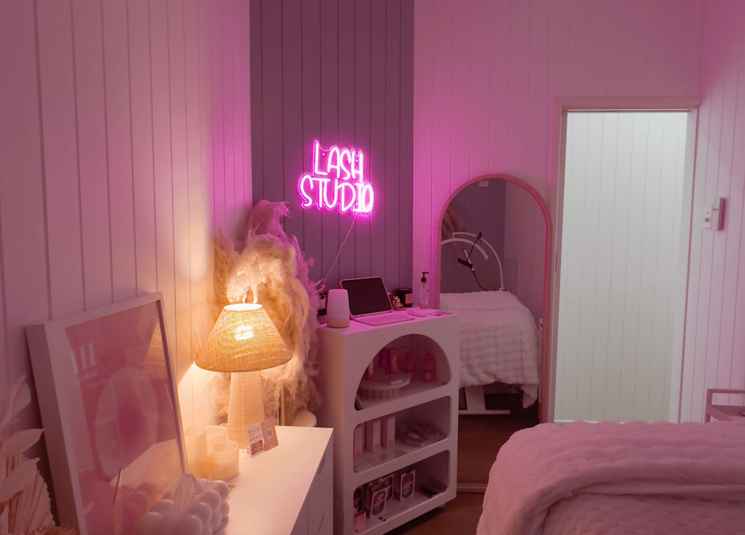 Cozy lash studio at Lyricstudiox, Saint Lucia, Queensland, AU with ambient pink lighting and elegant decor.