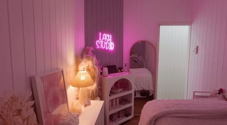 Cozy lash studio at Lyricstudiox, Saint Lucia, Queensland, AU with ambient pink lighting and elegant decor.