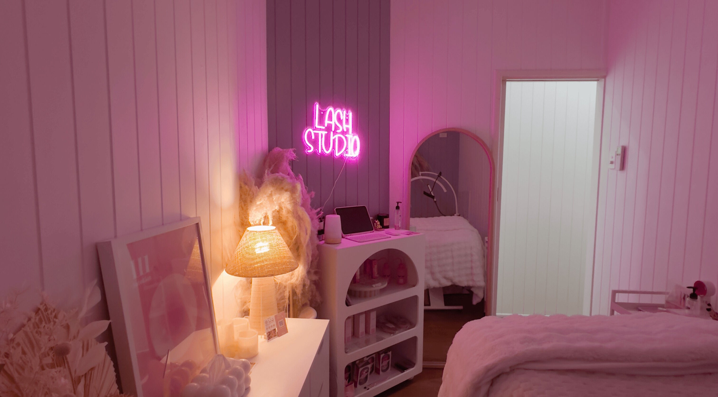 Cozy lash studio at Lyricstudiox, Saint Lucia, Queensland, AU with ambient pink lighting and elegant decor.