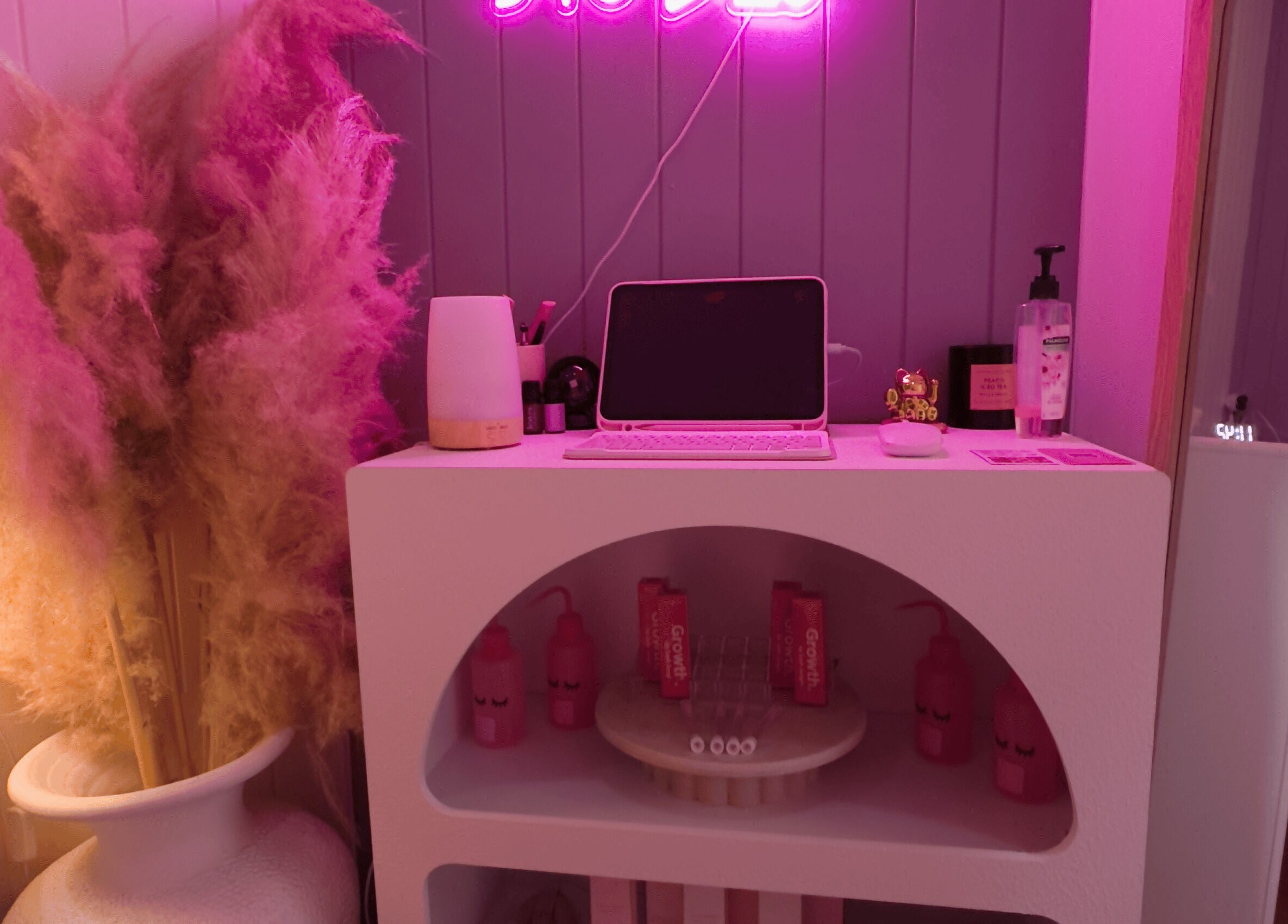 Chic Lyricstudiox beauty space with neon sign and pink accents in Saint Lucia, Queensland, AU.