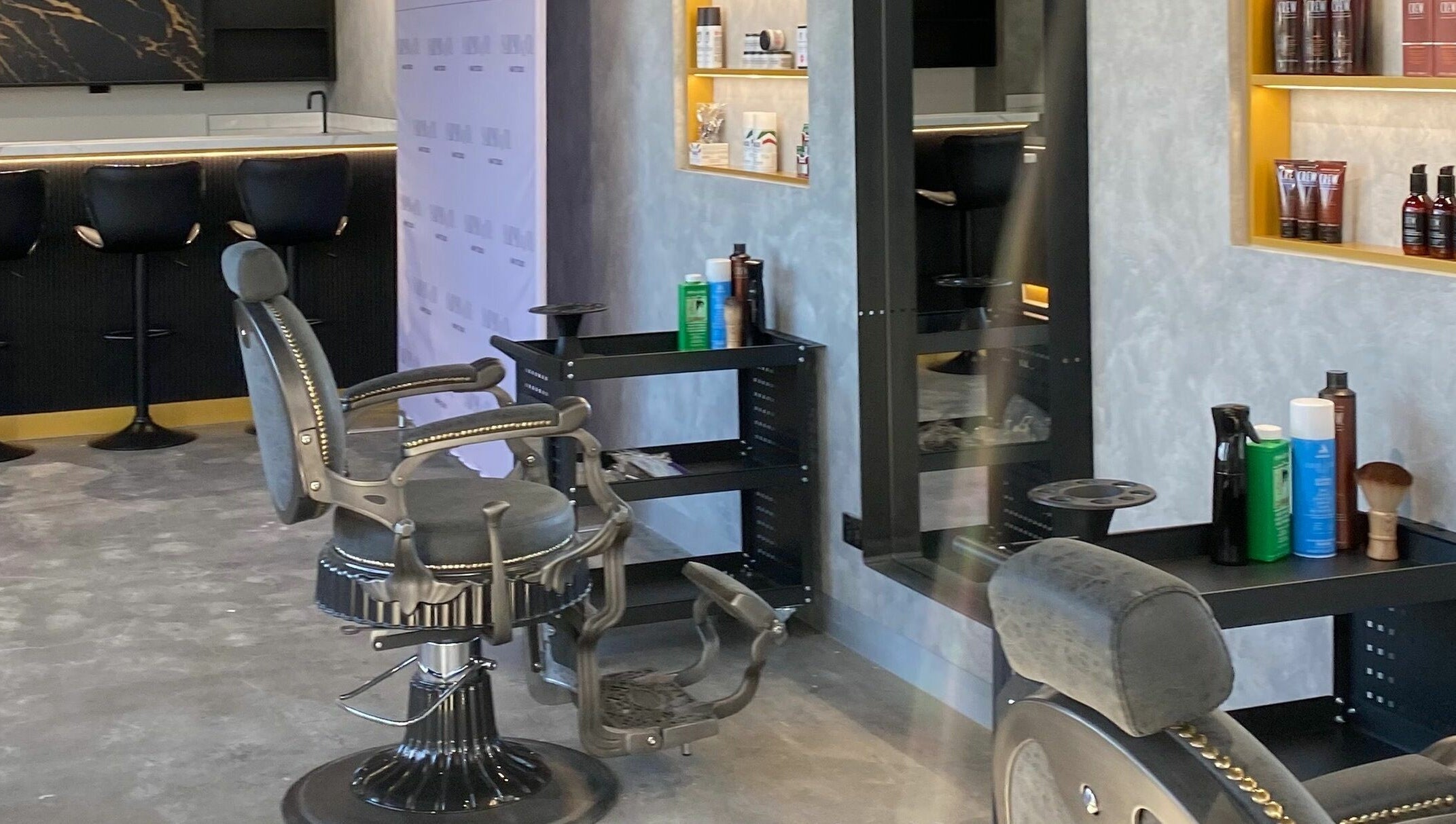 Elegant salon setup at Sarmo & Co., Melbourne, Victoria, AU, featuring stylish black chairs and grooming products.