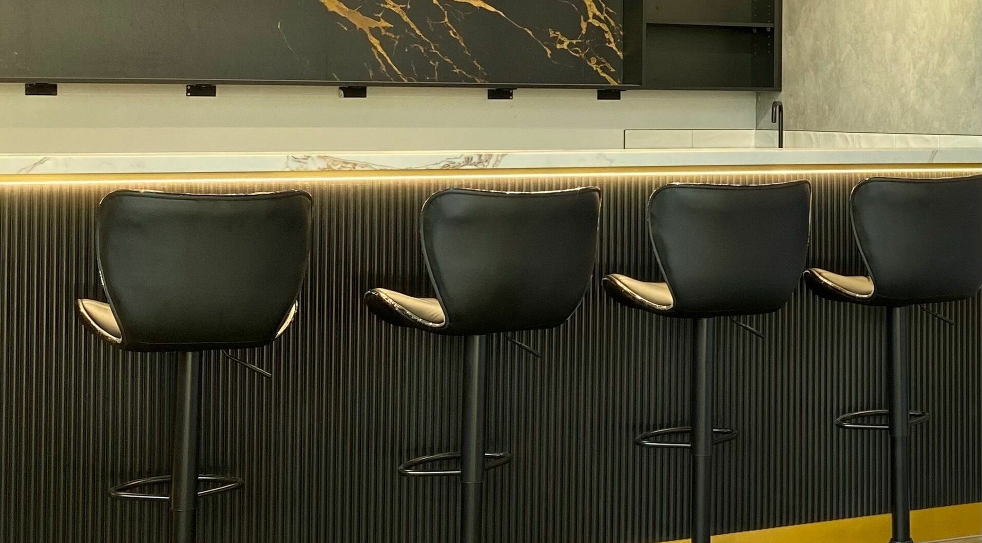 Contemporary seating at Sarmo & Co., Melbourne, Victoria, AU, featuring sleek black chairs and modern decor.