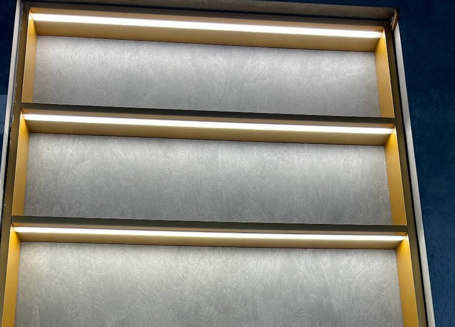 Illuminated wall shelves at Sarmo & Co. in Melbourne, Victoria, AU, showcasing modern design.