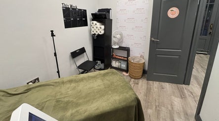 Cozy green treatment room at The Skin and Sculpt Studio, Ashton-under-lyne, England, GB.
