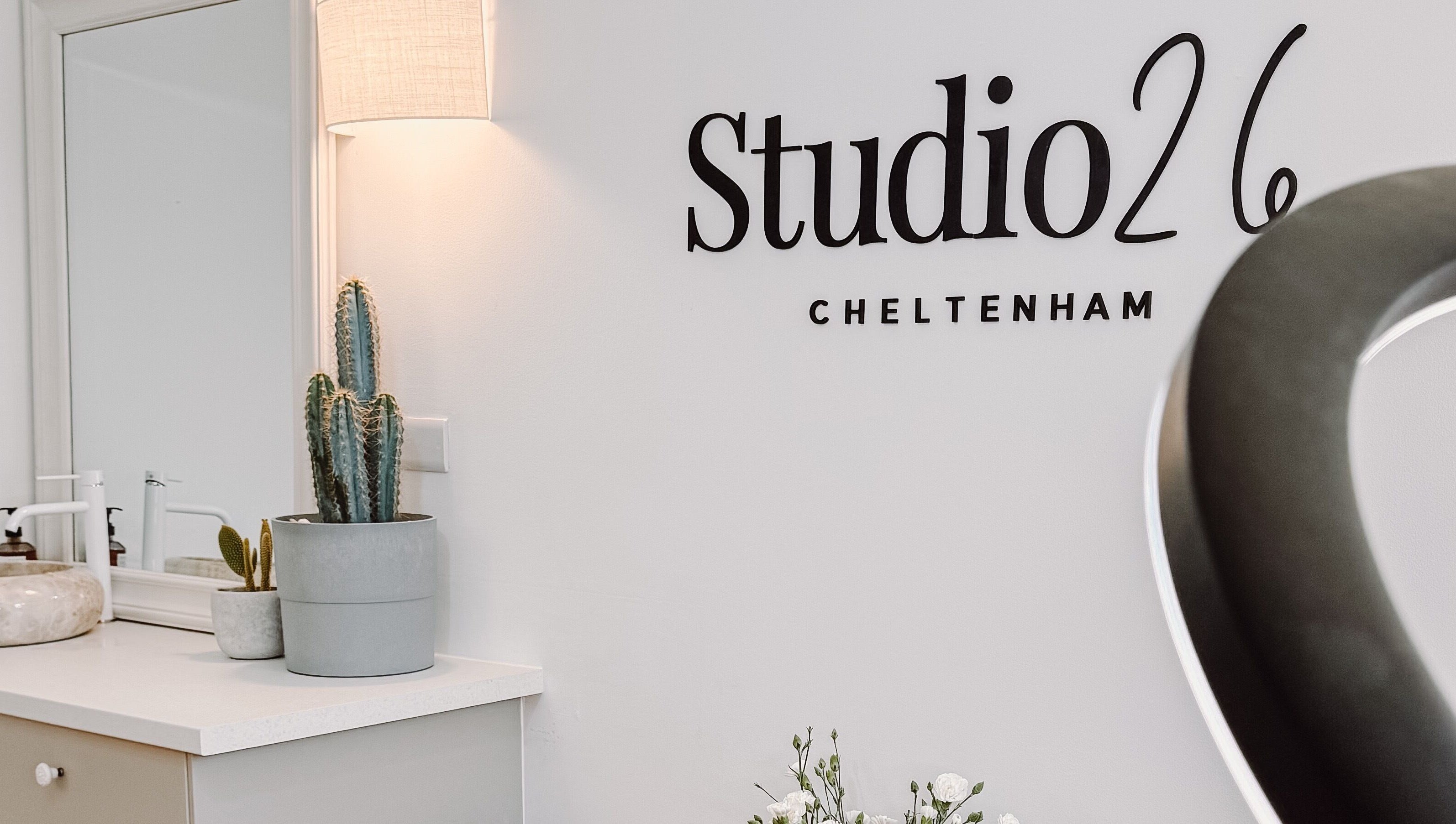 Elegant decor at Ola’s Studio26, a beauty venue in Cheltenham, England, GB, with stylish cacti and minimalist design.