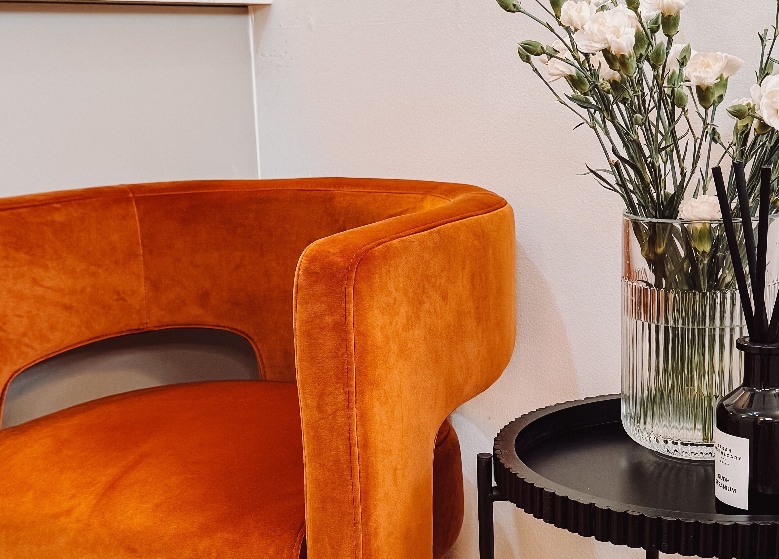 Stylish orange chair and floral decor at Ola’s Studio26, Cheltenham, England, GB.