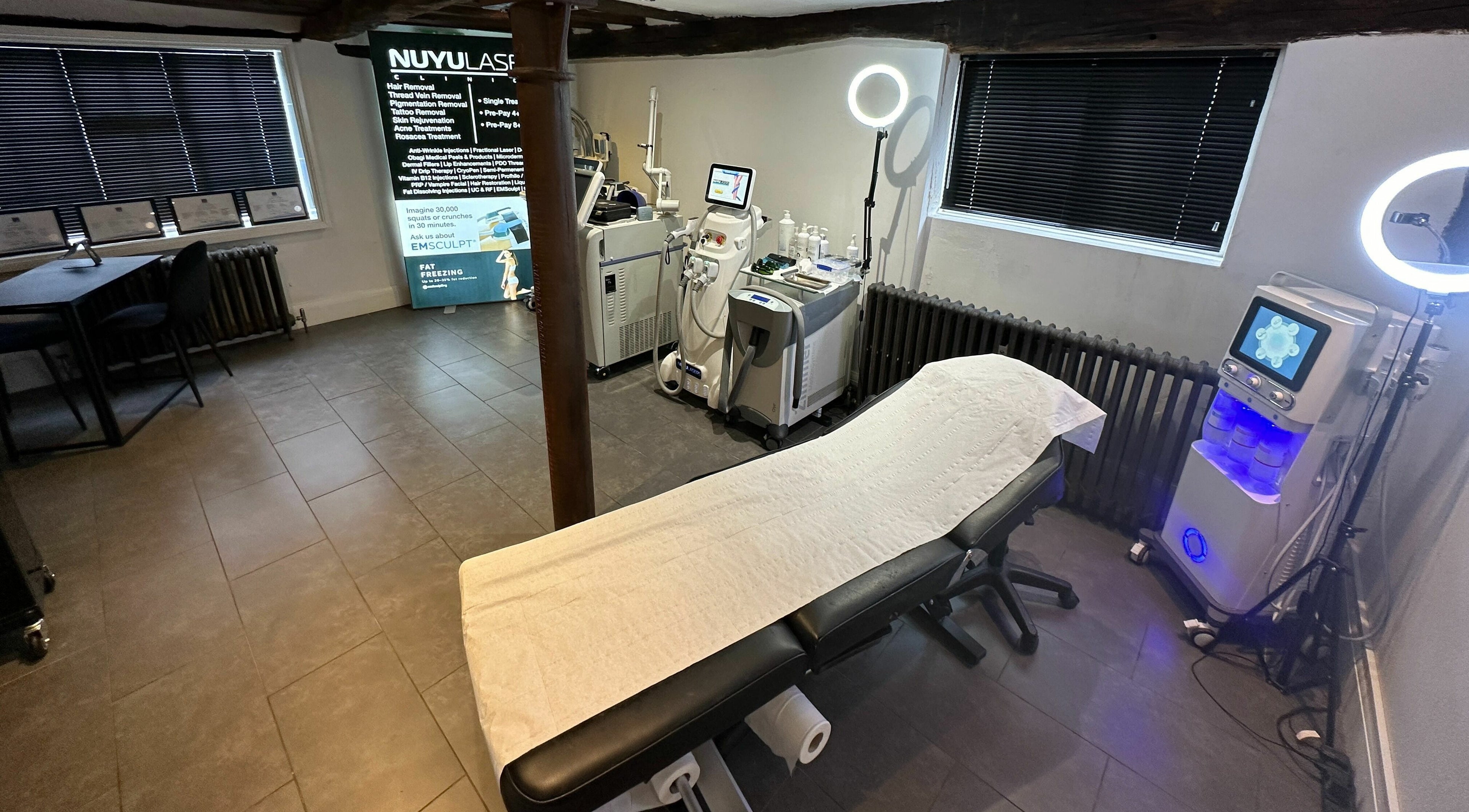 Modern treatment room at NUYU Laser & Aesthetics Clinics, Lichfield, England, GB, featuring advanced aesthetic equipment.