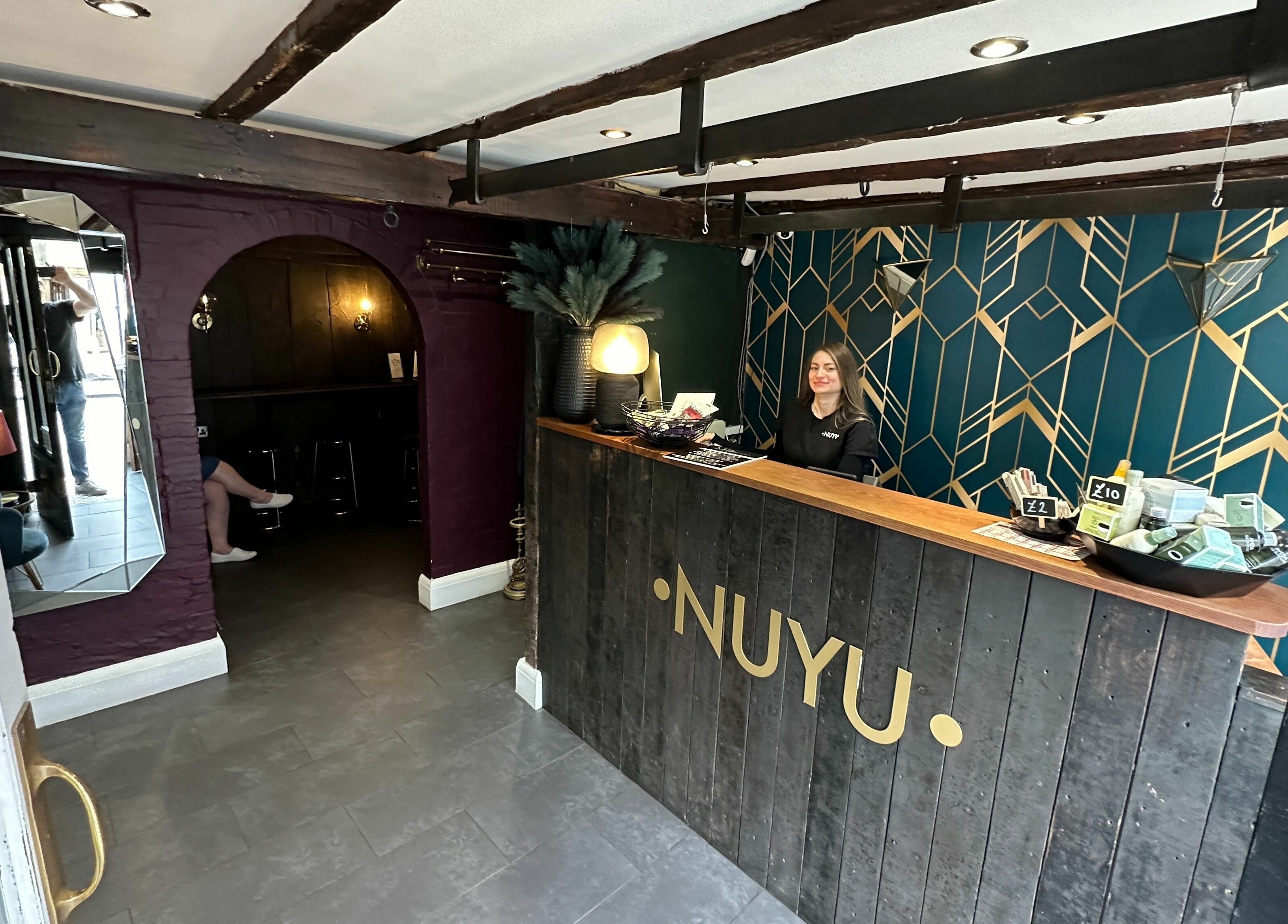 Reception area of NUYU Laser & Aesthetics Clinics in Lichfield, England, GB with geometric wall design.
