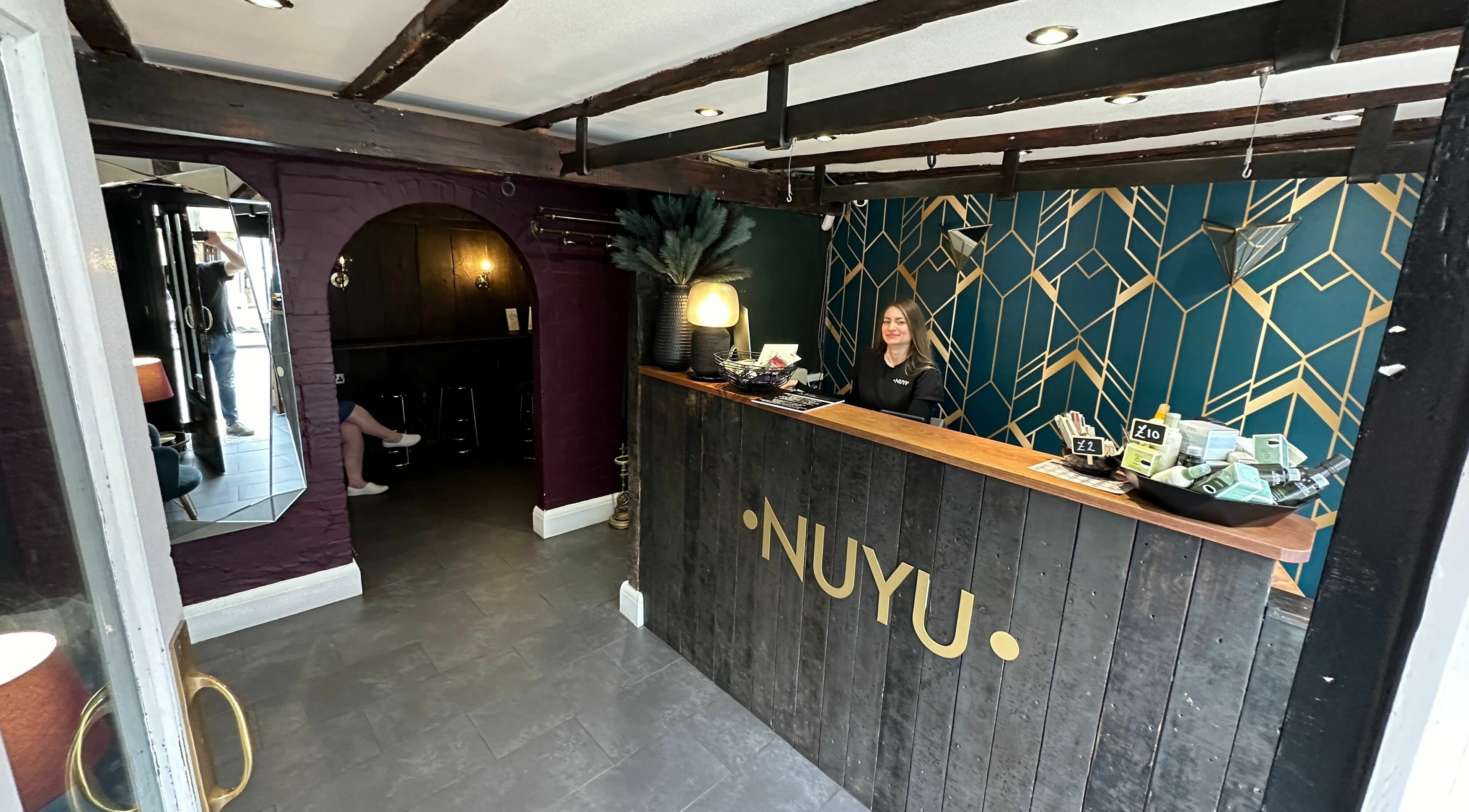 Reception area of NUYU Laser & Aesthetics Clinics in Lichfield, England, GB with geometric wall design.