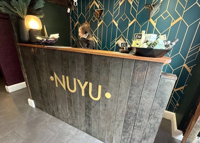 Reception area at Nuyu Hair & Beauty Salon, Lichfield, England, GB with modern décor and product displays.