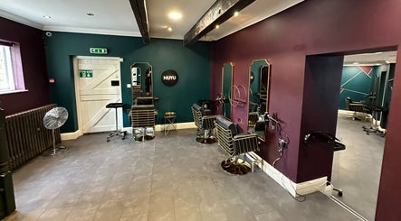 Modern interior of NUYU Hair & Beauty Salon Lichfield, featuring stylish chairs and mirrors in Lichfield, England, GB.