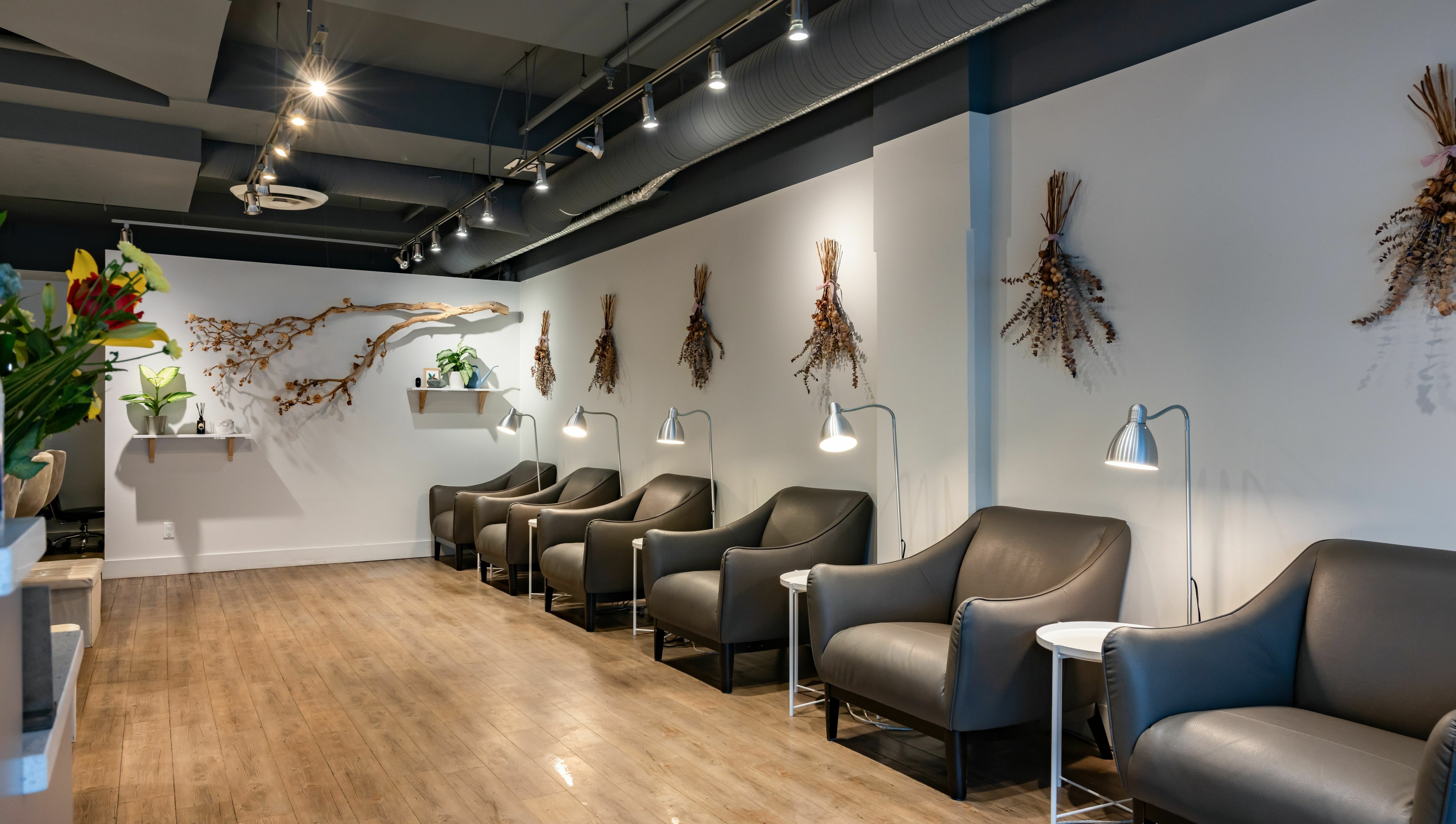 Stylish seating area at Lily & Roo Nail Salon, Vancouver, British Columbia, CA, with modern decor and ambient lighting.