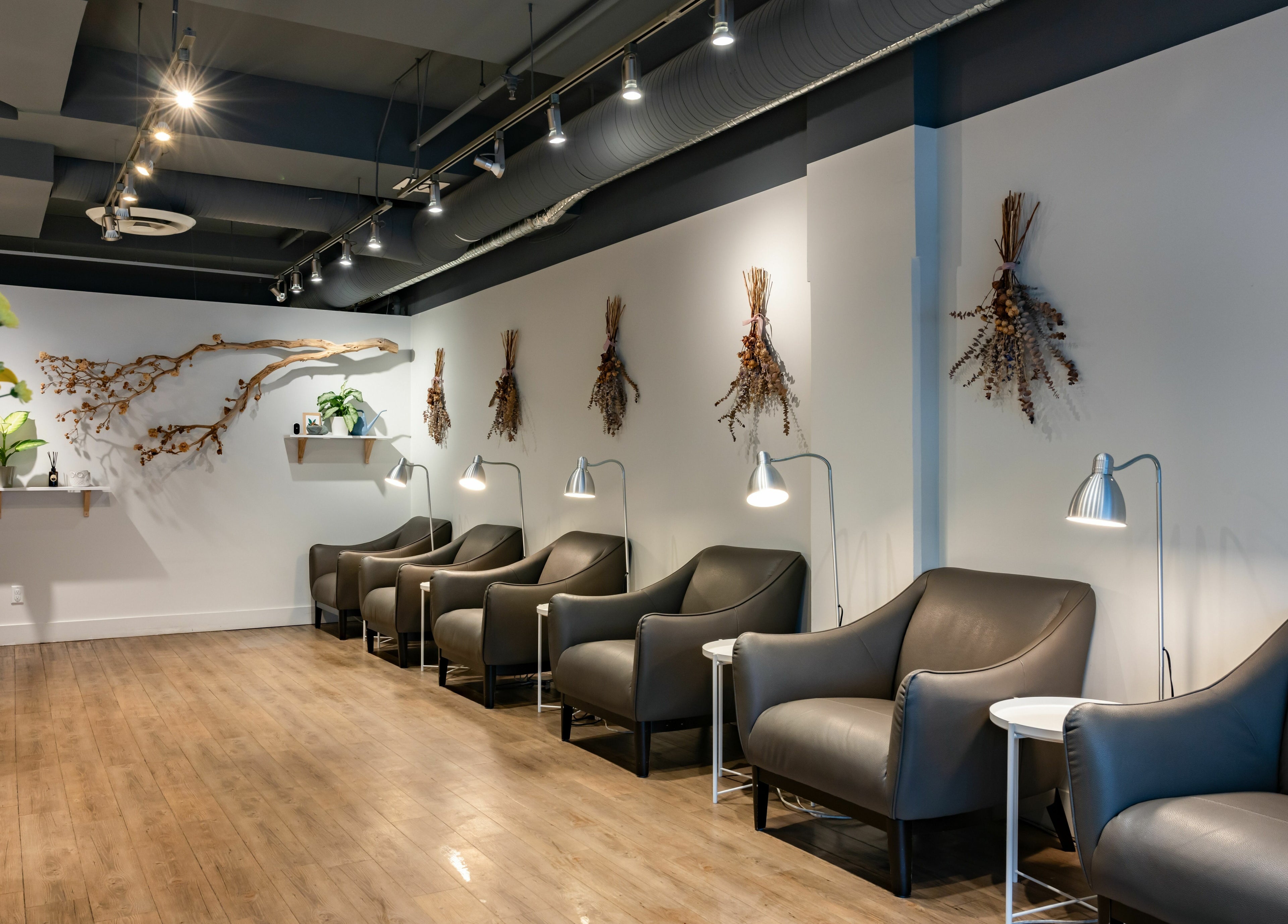 Stylish seating area at Lily & Roo Nail Salon, Vancouver, British Columbia, CA, with modern decor and ambient lighting.