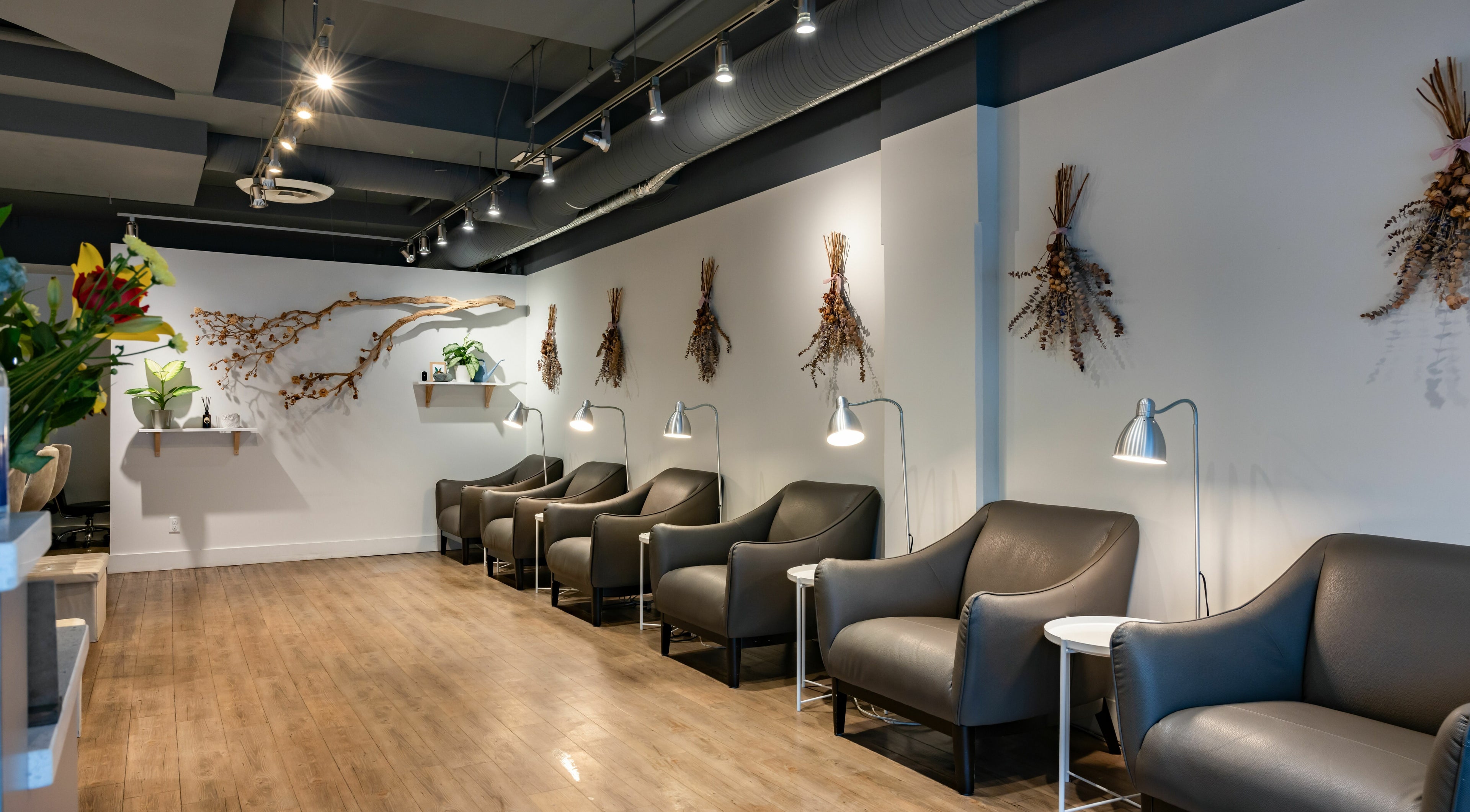 Stylish seating area at Lily & Roo Nail Salon, Vancouver, British Columbia, CA, with modern decor and ambient lighting.