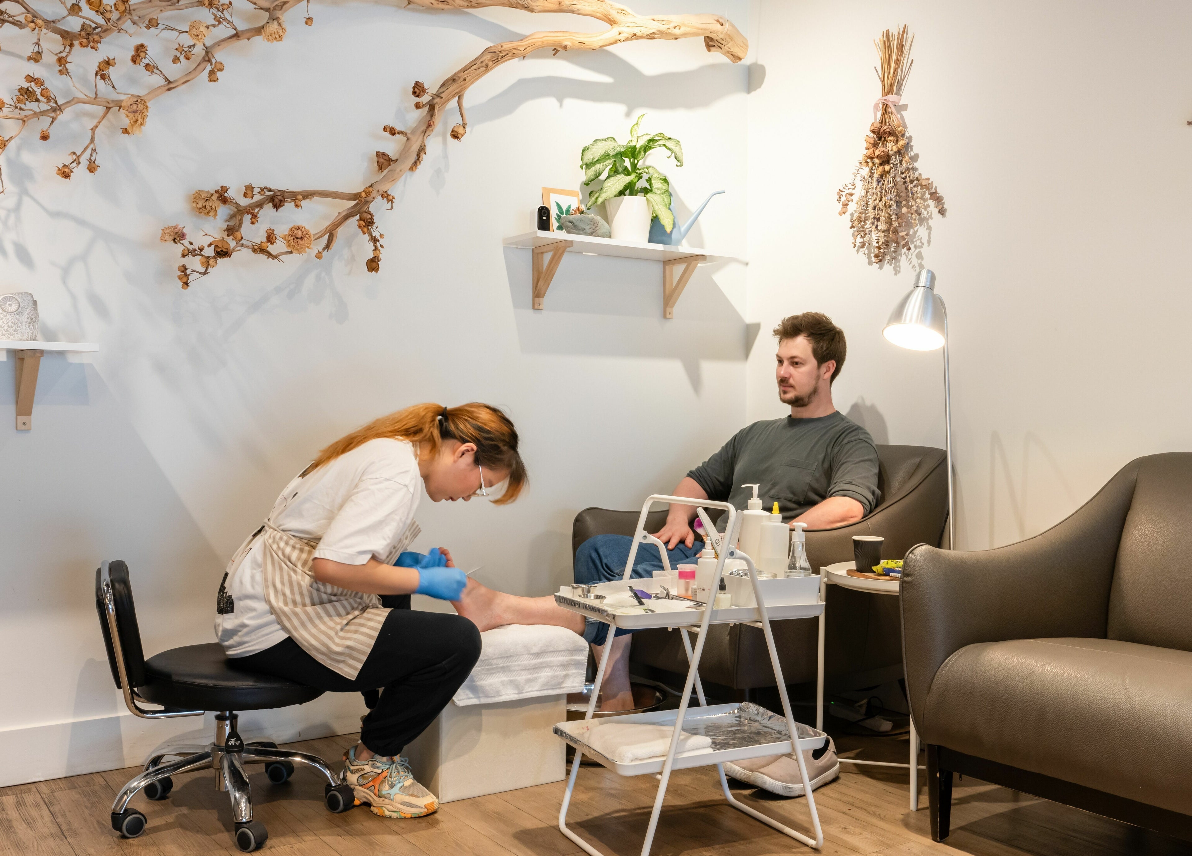 Pedicure service at Lily & Roo Nail Salon in Vancouver, British Columbia, CA with cozy seating and stylish decor.