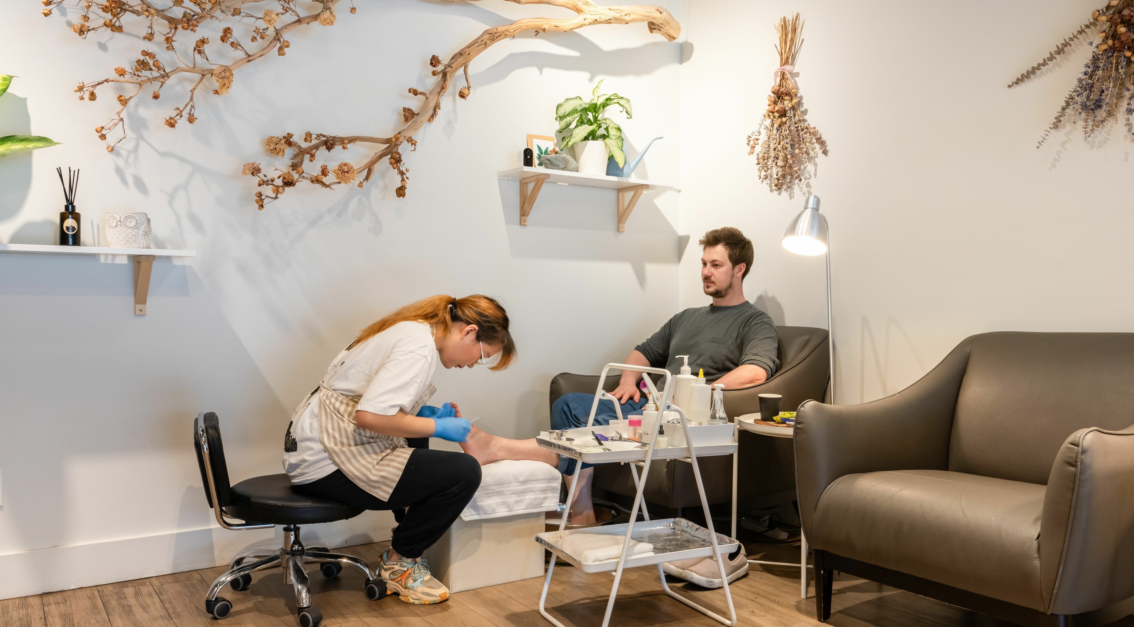 Pedicure service at Lily & Roo Nail Salon in Vancouver, British Columbia, CA with cozy seating and stylish decor.