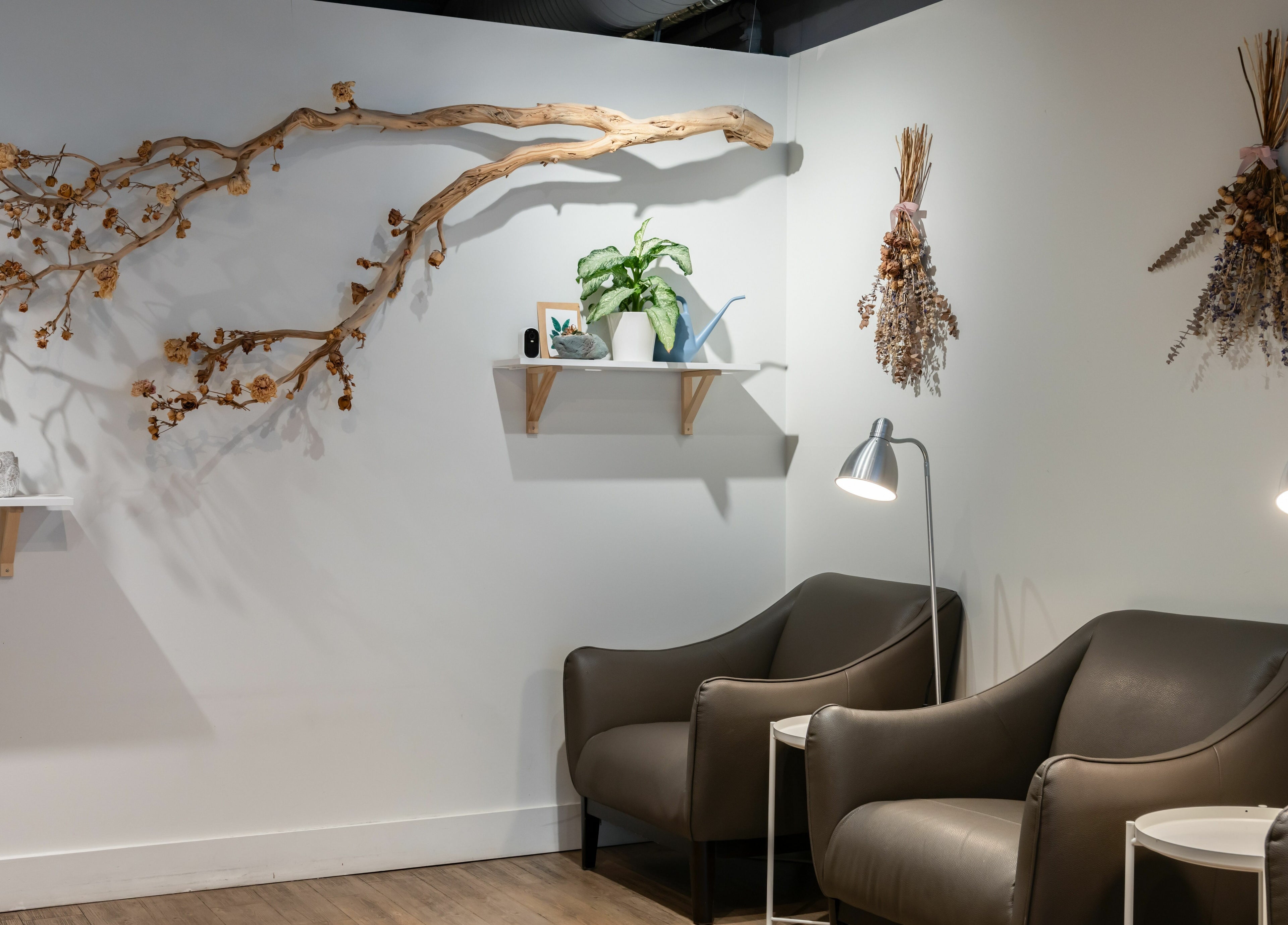 Comfortable seating area with decor at Lily & Roo Nail Salon in Vancouver, British Columbia, CA.
