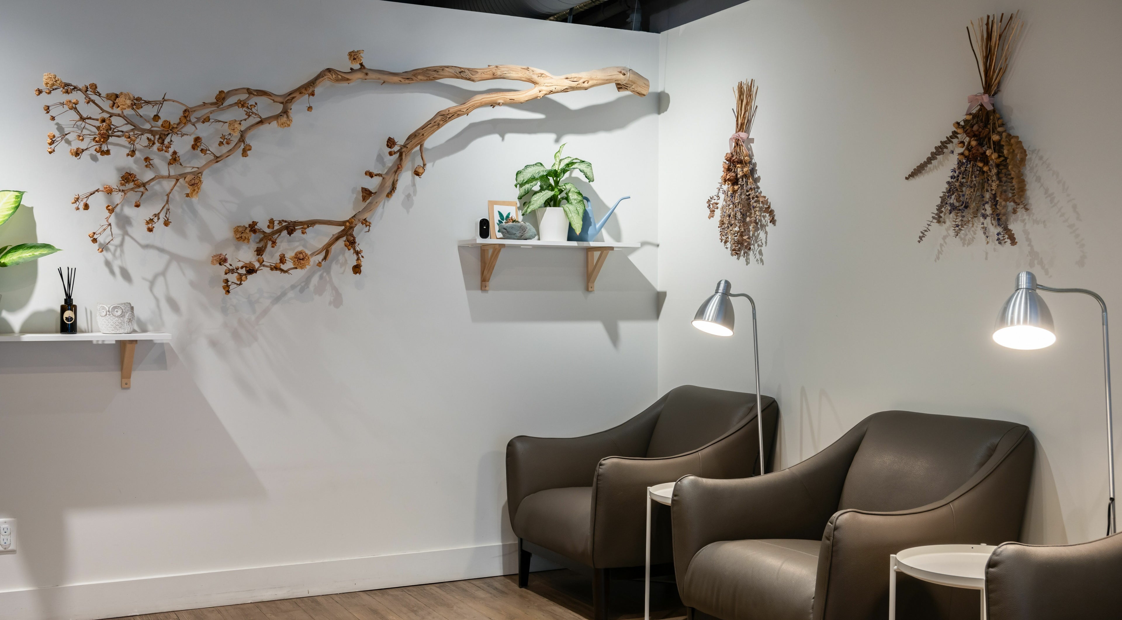 Comfortable seating area with decor at Lily & Roo Nail Salon in Vancouver, British Columbia, CA.