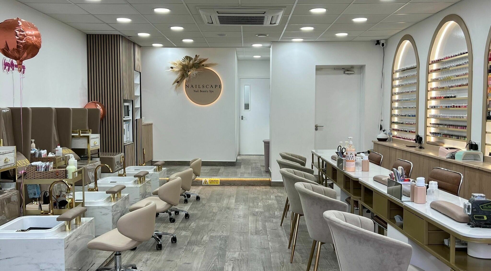 Interior of NAILSCAPE Ealing, a chic nail and beauty spa in London, England, GB with elegant decor and seating.