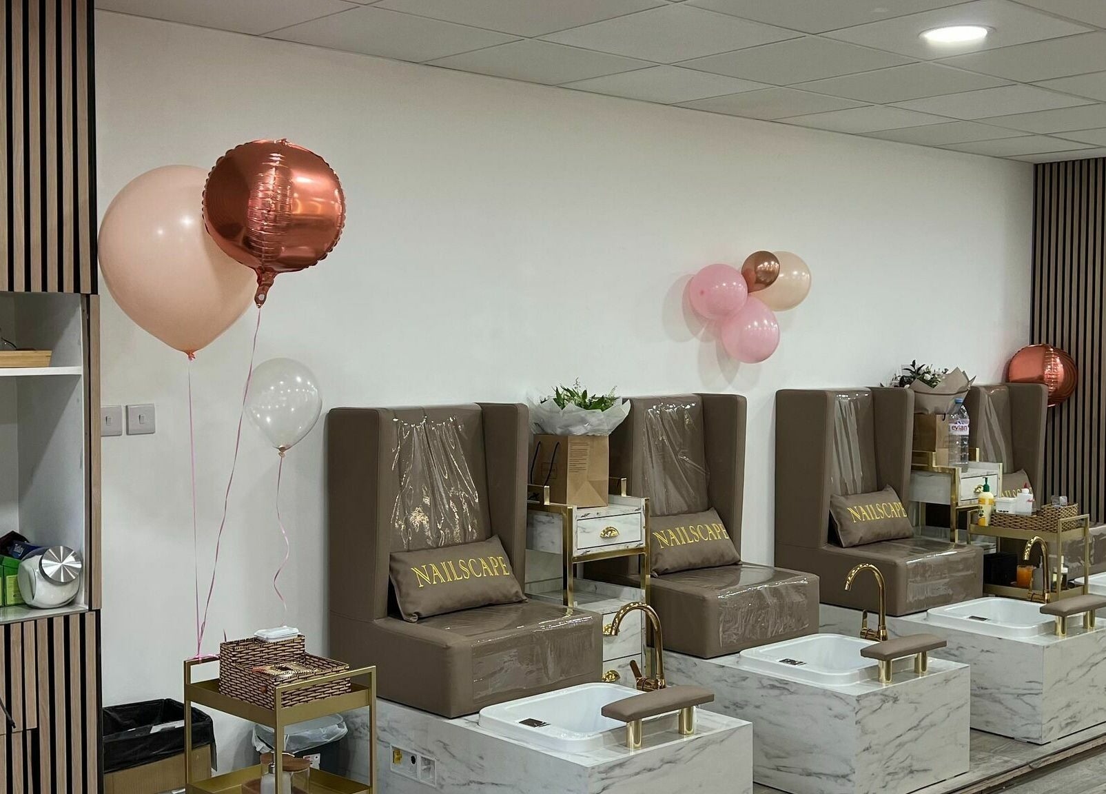 Elegant pedicure stations at NAILSCAPE Ealing, London, England, GB with chic seating and balloons.