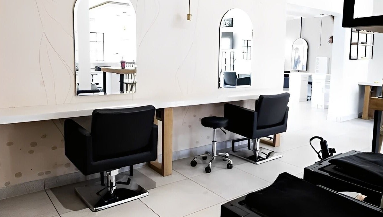 Salon at 102 in Rustenburg, North West, ZA, showcases modern styling stations with sleek mirrors and chairs.