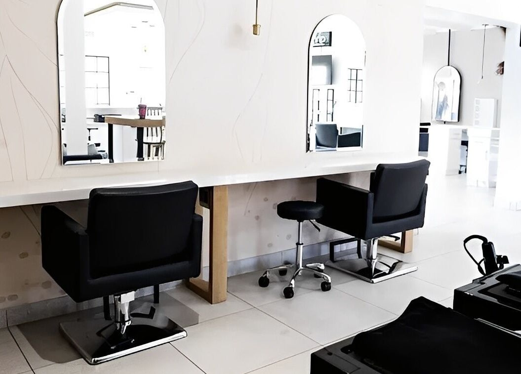 Salon at 102 in Rustenburg, North West, ZA, showcases modern styling stations with sleek mirrors and chairs.