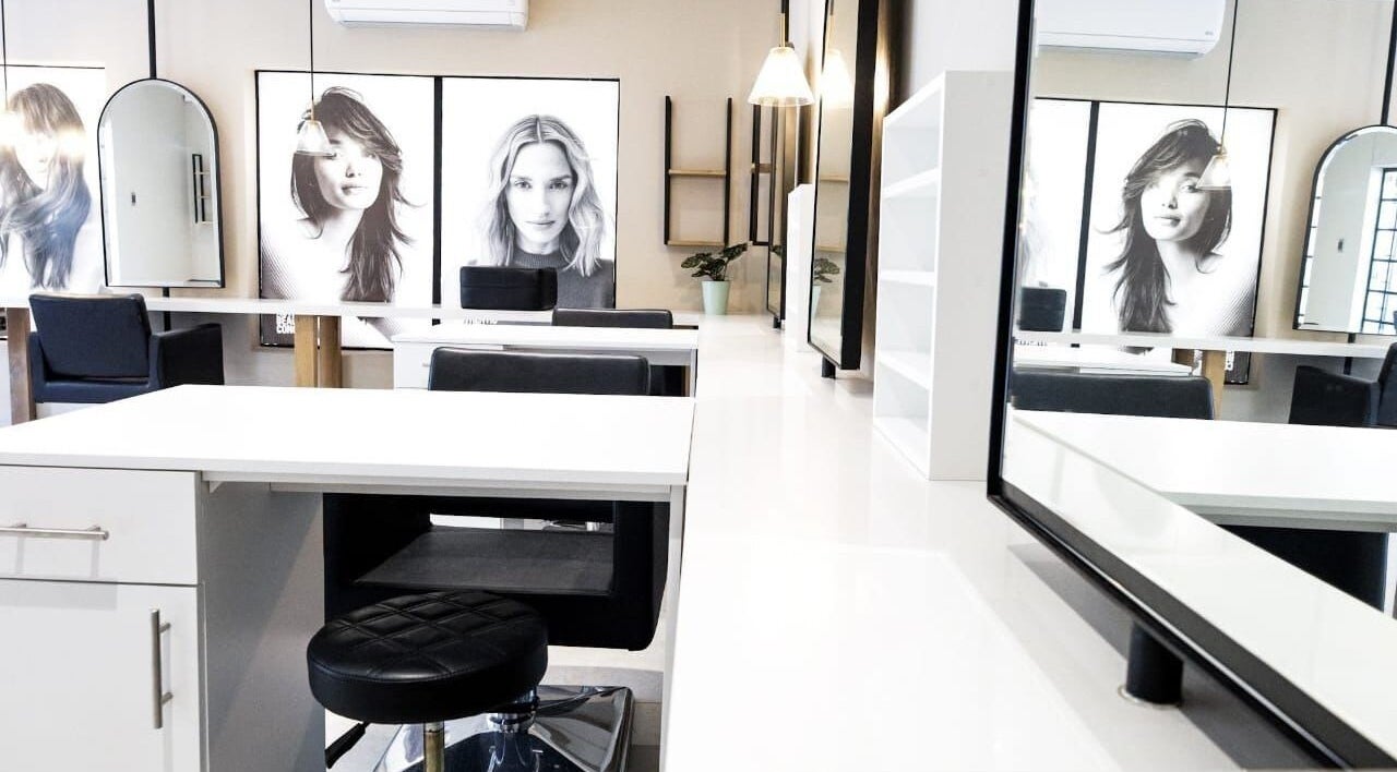 Modern interior of Salon at 102 in Rustenburg, North West, ZA, featuring stylish workstations and decor.