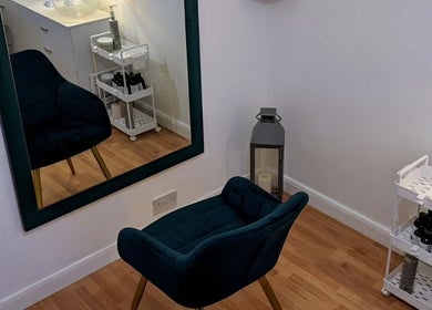Elegant styling area at Abbie Bellchambers Hair Salon in Shepshed, England, GB featuring a plush chair and mirror.