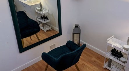 Elegant styling area at Abbie Bellchambers Hair Salon in Shepshed, England, GB featuring a plush chair and mirror.