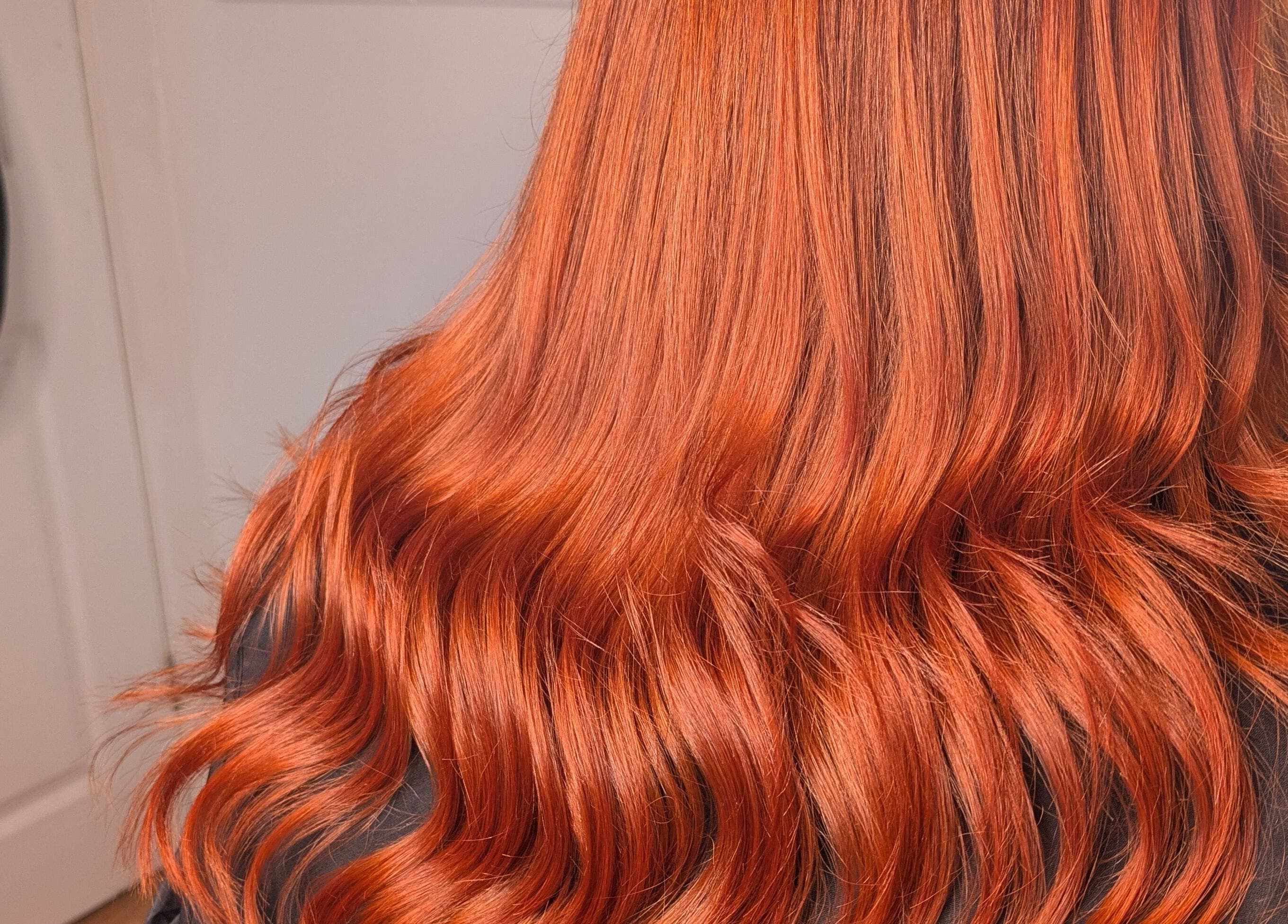 Vibrant copper hair styled in waves at Abbie Bellchambers Hair Salon in Shepshed, England, GB.