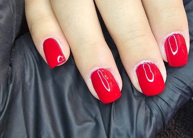 Red manicured nails at All Things Beauty, Wakefield, England, GB, showcasing expert nail artistry.