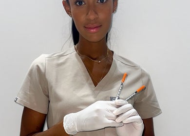 Aesthetic professional at Glow By Eve - Skin in Bedworth, England, GB holding syringes ready for a procedure.