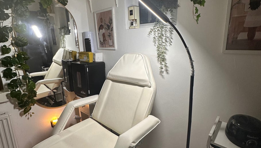 Relaxing treatment room at Crown Beauty and Aesthetics, London, England, GB, featuring a plush chair and soft lighting.
