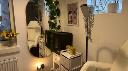 Cozy treatment room at Crown Beauty and Aesthetics in London, England, GB, adorned with plants and warm lighting.