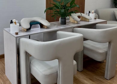Luxurious manicure station at 13: Thirteen Beauty Lounge in Dubai, Dubai, AE with plush chairs and greenery.