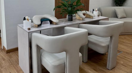 Luxurious manicure station at 13: Thirteen Beauty Lounge in Dubai, Dubai, AE with plush chairs and greenery.